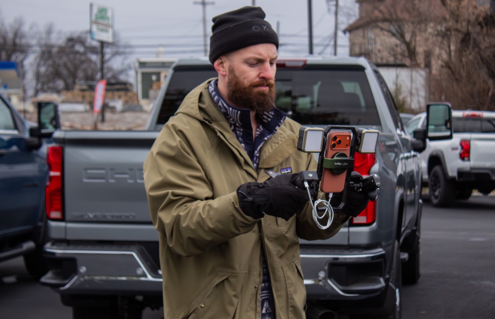 Josh checking footage on his phone in a truck