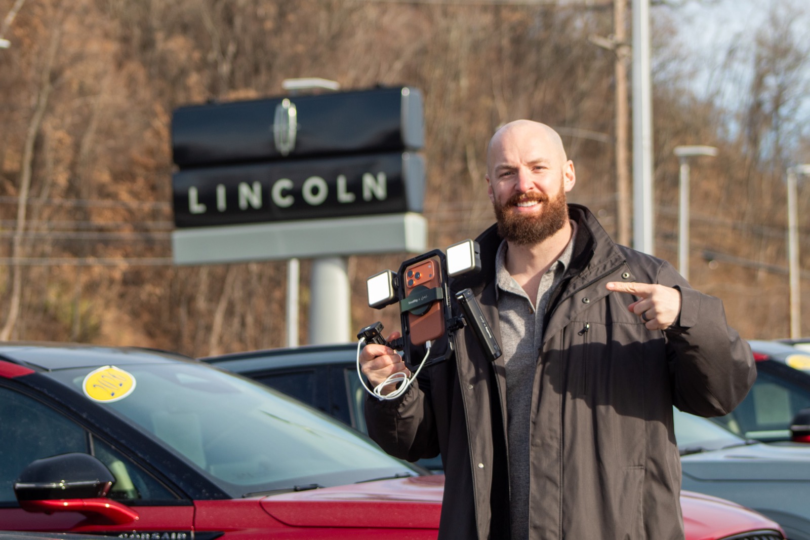 Josh, founder of Jams Creative Co., on a dealership lot with his filming rig